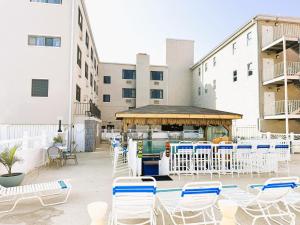 a patio with chairs and a bar in a building at Oceanic Hotel in Wildwood