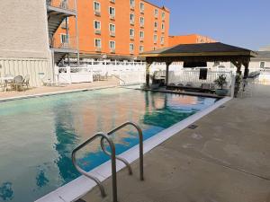 a swimming pool with a gazebo next to a building at Oceanic Hotel in Wildwood +14 photos