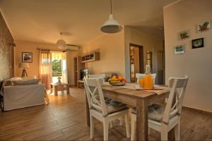 a dining room with a wooden table and chairs at Apartment Hotteamo in Silba