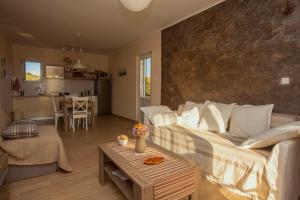 a living room with a white couch and a table at Apartment Hotteamo in Silba