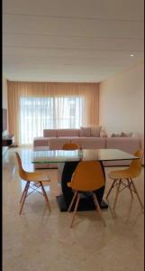 a living room with a couch and a table and chairs at Peninsula promenade in Tamaris