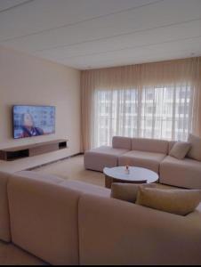 a living room with a couch and a table at Peninsula promenade in Tamaris