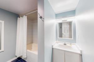 a white bathroom with a sink and a tub at Wintergreen 116 in Blue Mountains +37 photos