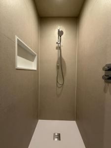 a bathroom with a shower with a camera on the wall at Casa Martens in Monda