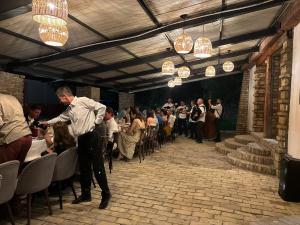 a man is standing in front of a crowd of people at Imanje Dorf in Ravno Selo +52 photos