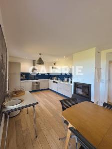 a large living room with a table and a fireplace at GC - Villa L'Idéal - Vue Mer in Hervelinghen +48 photos