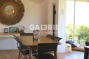 a dining room table with chairs and a mirror at GC - Villa L'Idéal - Vue Mer in Hervelinghen
