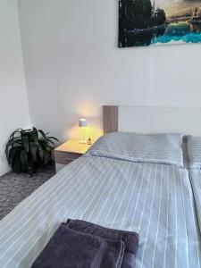 a bedroom with a bed and a desk with a lamp at Apartmán Líšný - U Jizery in Líšný