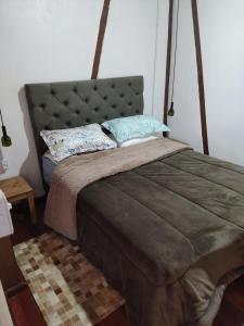 a bed with two pillows on it in a bedroom at Frida's Haus in Nova Petrópolis
