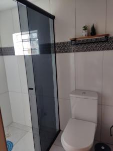 a bathroom with a toilet and a glass shower at Frida's Haus in Nova Petrópolis +28 photos