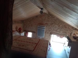 a bedroom with a bed in a stone wall at petite maison Bellevue in La Celle-sous-Gouzon