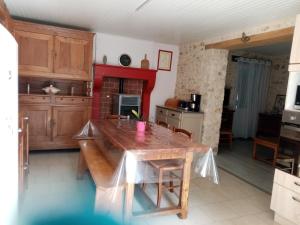 a kitchen with a wooden table in a room at petite maison Bellevue in La Celle-sous-Gouzon