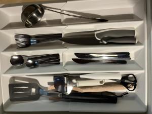 a drawer full of kitchen utensils in a refrigerator at Ūbelītes in Pērkone +22 photos
