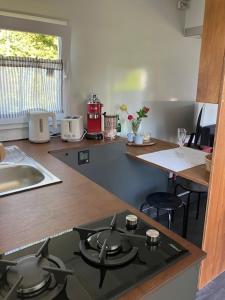 a kitchen with a stove and a counter top at Reetblick in Haseldorf +13 photos