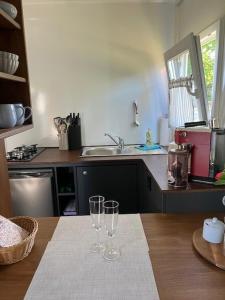 two wine glasses sitting on a table in a kitchen at Reetblick in Haseldorf