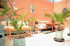a living room with two potted plants on a table at Riad Dar Lokman in Marrakesh