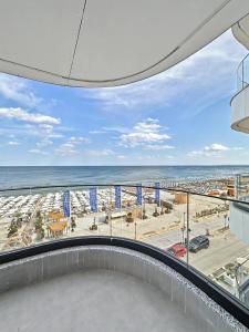 a balcony with a view of the beach and the ocean at Tomis Villa Grand Resort in Mamaia Sat/Năvodari