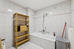 a white bathroom with a tub and a shower at Casa Materi Geldersheim in Geldersheim +22 photos