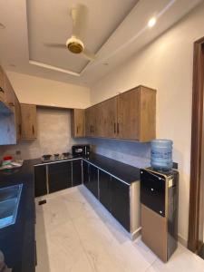 a kitchen with wooden cabinets and a counter top at SA Farms in Lahore