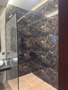 a shower with a glass door in a bathroom at SA Farms in Lahore +11 photos