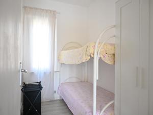 a bedroom with a white bed and a window at M473 - Marcelli, trilocale con posto auto e wifi in Marcelli