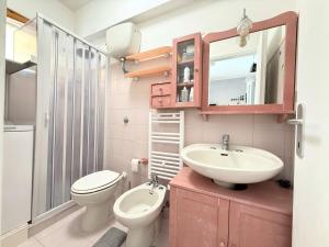 a bathroom with a sink and a toilet and a mirror at M473 - Marcelli, trilocale con posto auto e wifi in Marcelli +9 photos