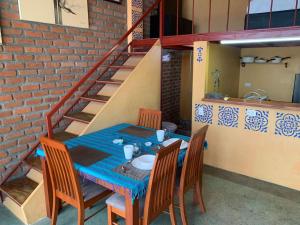 a table and chairs with a table and a staircase at Mar en Casa - Taganga - Vista al Mar in Taganga +43 photos
