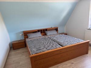 a bed with two pillows on it in a room at Ferienhaus Tal in Geislingen