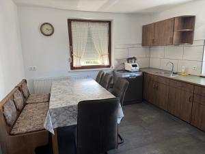 a kitchen with a table and chairs and a sink at Ferienhaus Tal in Geislingen +9 photos