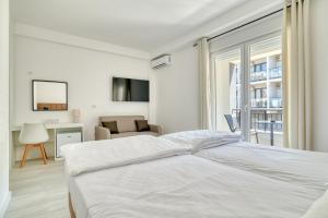 a white bedroom with a bed and a living room at Hotel Opera Jaz in Budva +72 photos