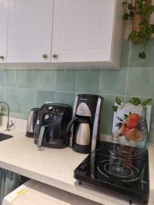 a kitchen counter with a coffee maker and a toaster at Céu Sol Sul in Porto Alegre