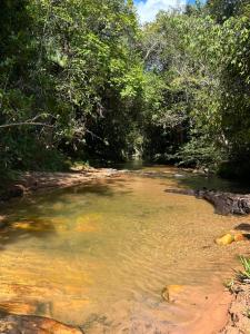 a river with a bunch of trees in the background at Santuário da Chapad a dos Veadeiros in Alto Paraíso de Goiás +94 photos