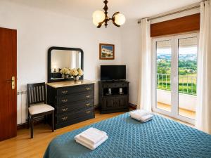 a bedroom with a bed and a dresser and a mirror at Casa Machado in Vila Real