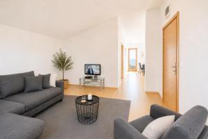 a living room with a couch and a table at SunSeoce Apartments in Budva
