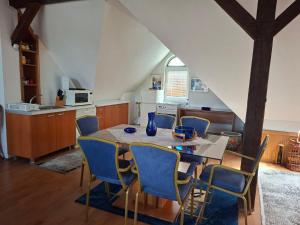 a kitchen with a table and chairs in a room at Ace Apartments in Bitola