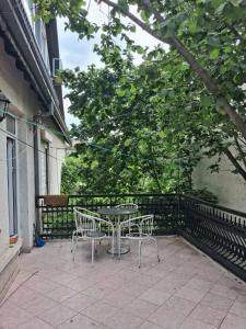 a patio with a table and chairs on a balcony at Ace Apartments in Bitola