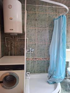 a bathroom with a washing machine and a toilet at Ace Apartments in Bitola