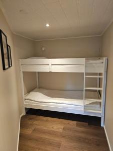 a white bunk bed in a room at Sandmo Holiday Home 13 in Eckerö