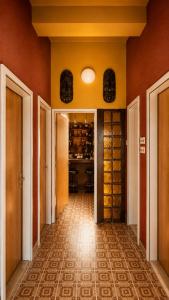 an empty hallway with orange walls and a kitchen at Polaroid House '76 in Radovici +38 photos