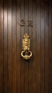 a door with a gold door knocker on a wooden door at Polaroid House '76 in Radovici