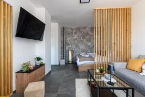 a living room with a couch and a bed at Apartman Kika Knjaževac in Knjazevac.