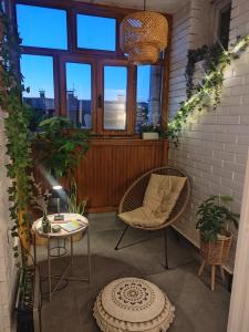 a patio with two chairs and a table and a window at Apartman Kika Knjaževac in Knjazevac.