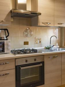 a kitchen with a stove and a sink at DaMaHouse in Monastir