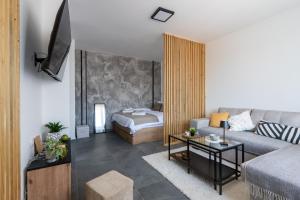a living room with a couch and a bed at Apartman Kika Knjaževac in Knjazevac.