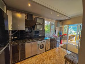 a kitchen with a washer and dryer in it at Gald Garden in Dilijan