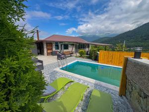 a house with a swimming pool in front of a house at Gald Garden in Dilijan