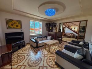 a large living room with couches and a television at Gald Garden in Dilijan