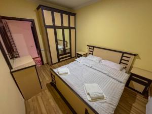 a bedroom with a bed with two towels on it at Gald Garden in Dilijan +18 photos