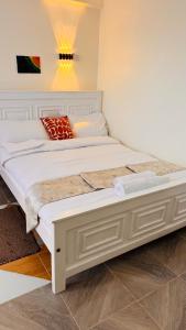 a large white bed in a room at Stlounge-kisaju in Stony Athi