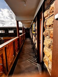 a corridor of a building with a brick wall at Stlounge-kisaju in Stony Athi